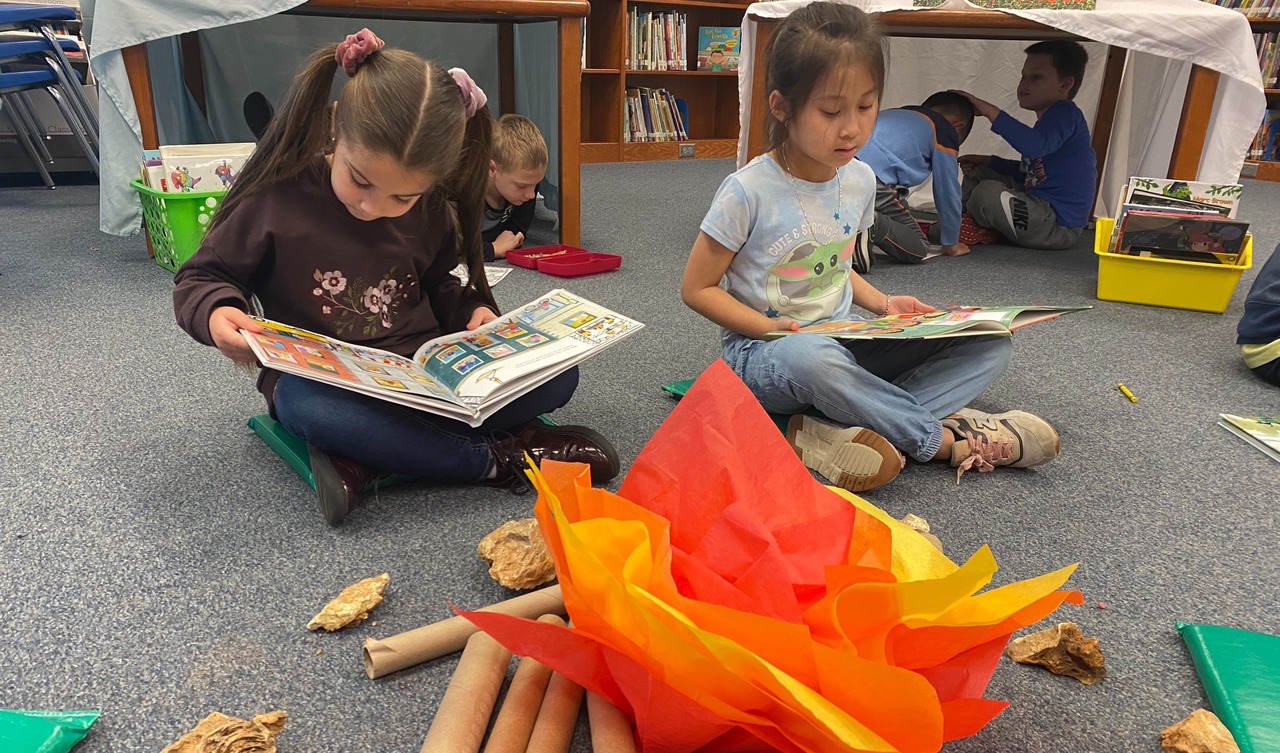 Students reading in front of a pretend