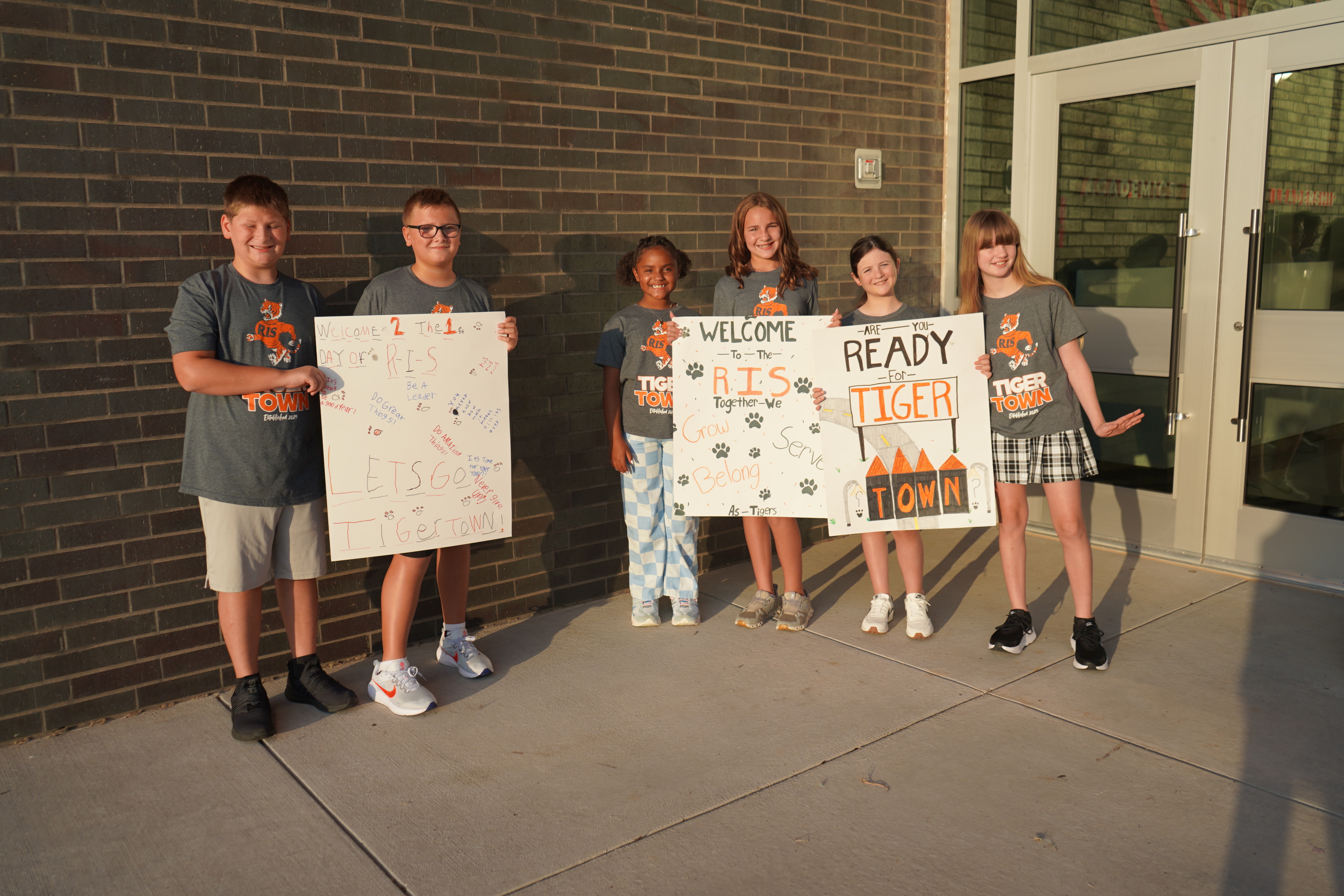 Students standing together holding signs