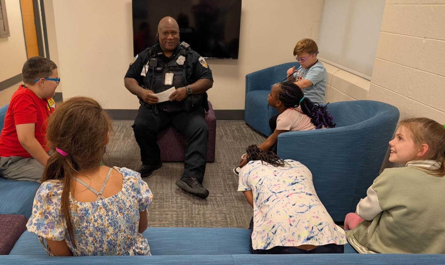 Officer Wemberly speaking with a group of Kramer Hall students.