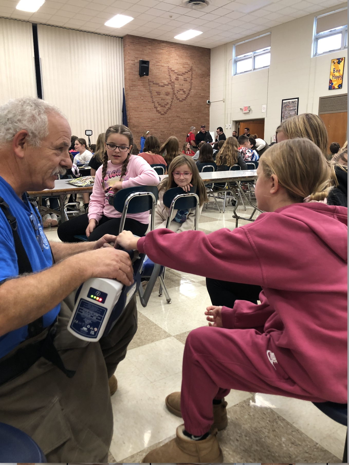 Fireman introduces fire department gear to students