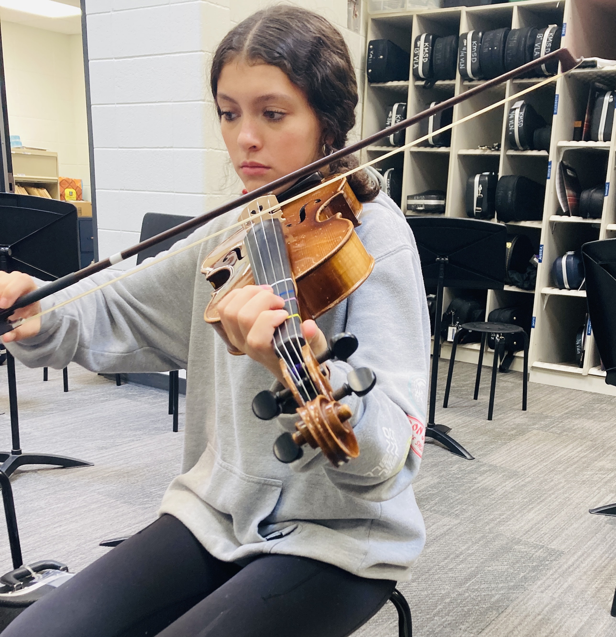 Student playing string instrument