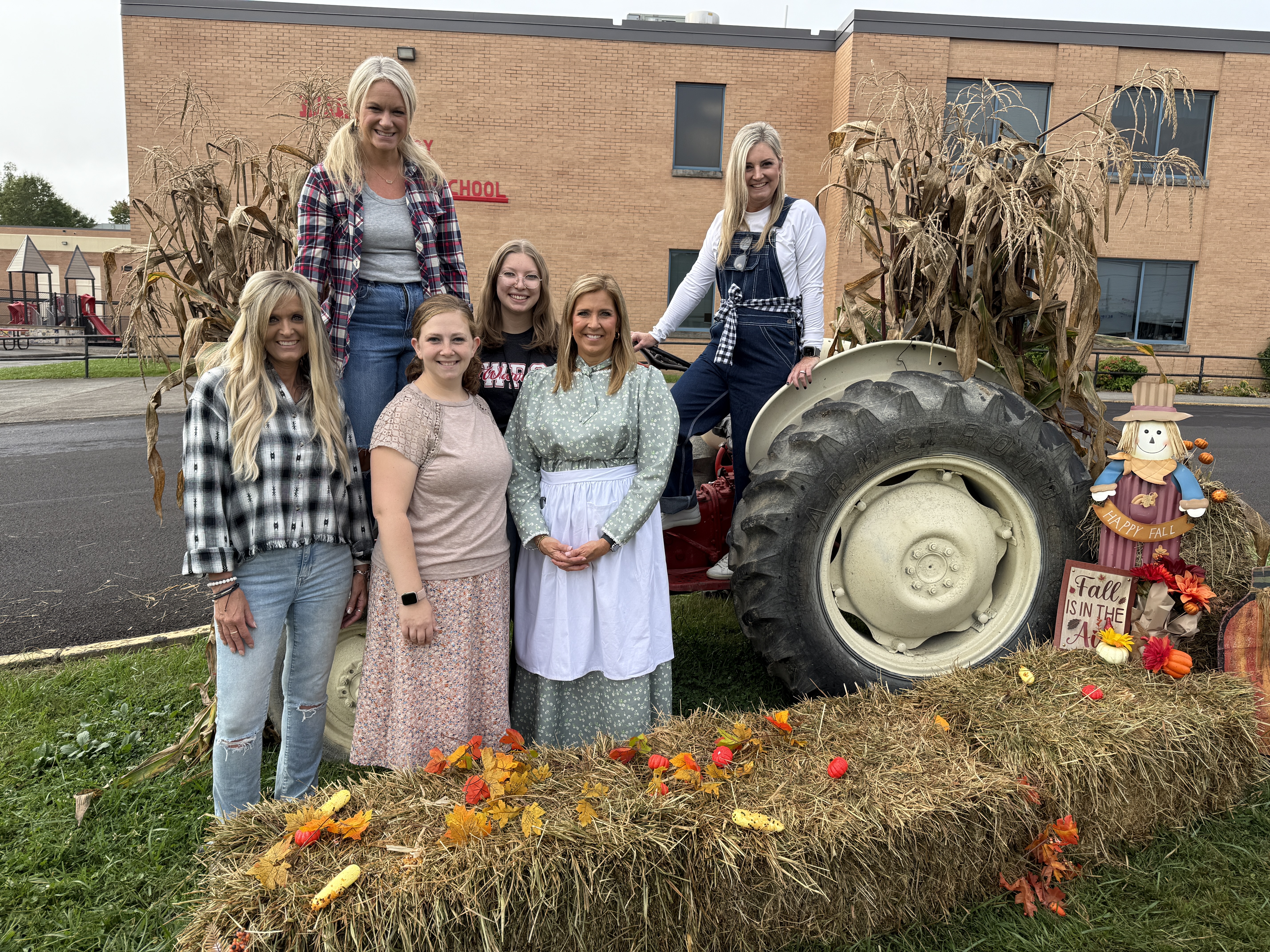 Teachers pose for a picture on the playground
