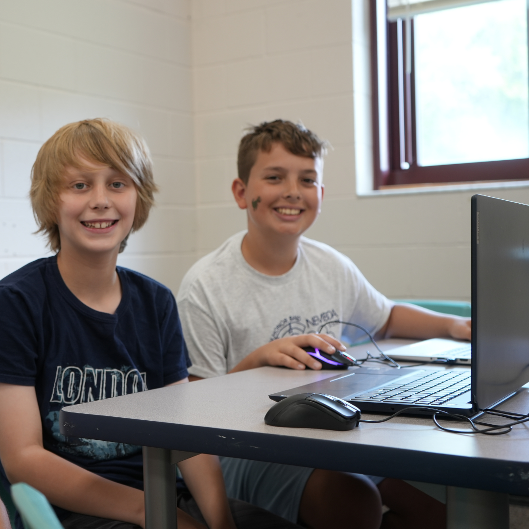 Two students playing esports on laptop