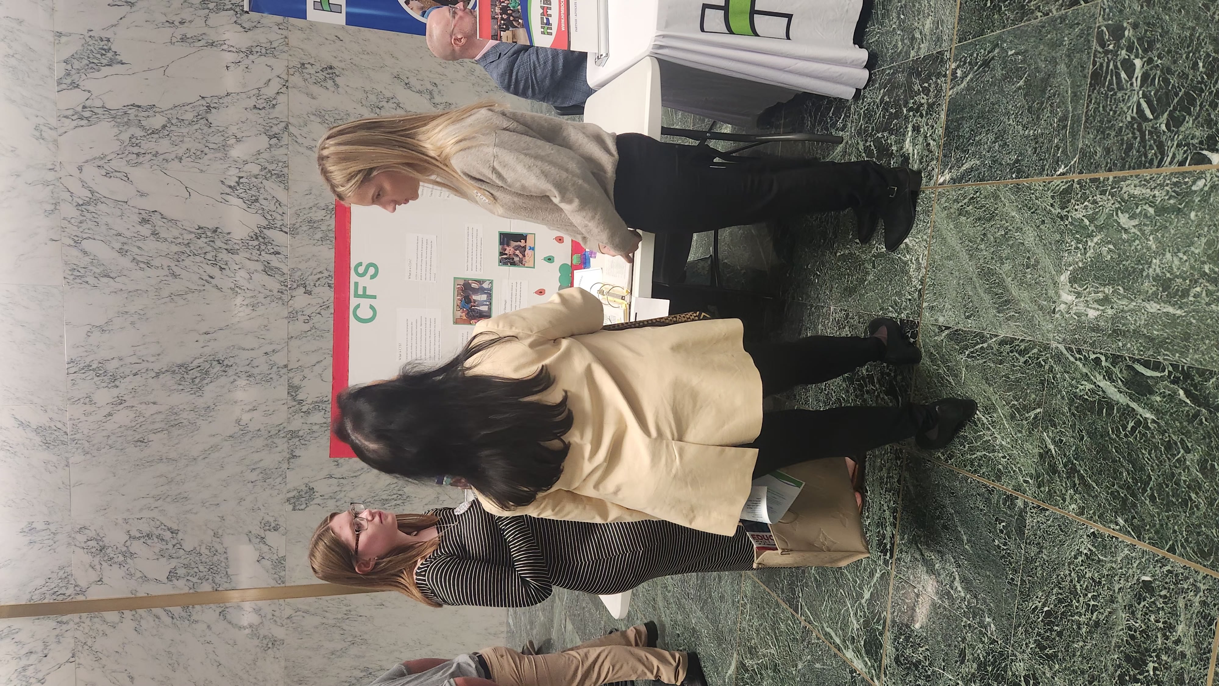 Two students and education commissioner talking