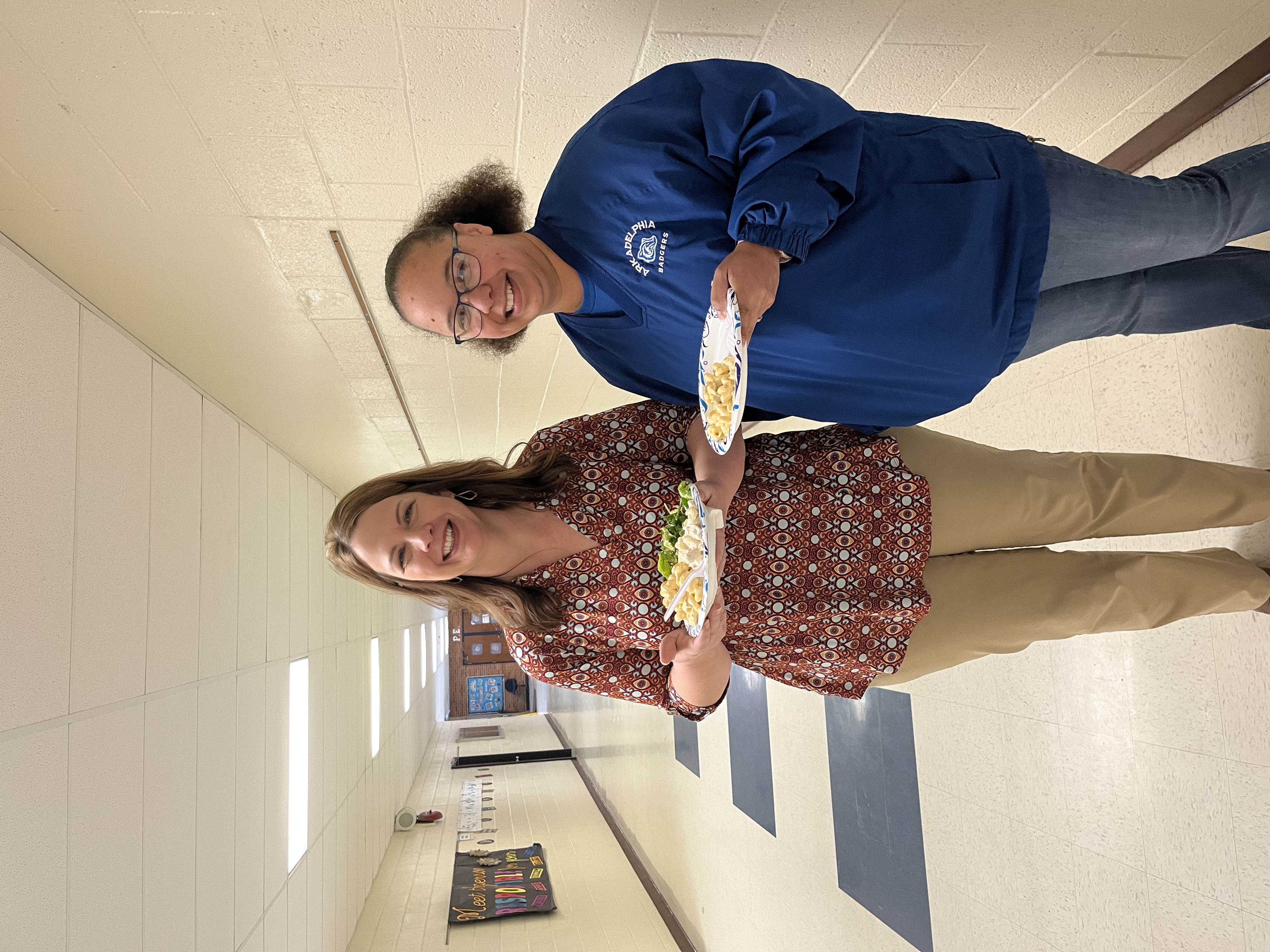 Teachers smiling holding plates