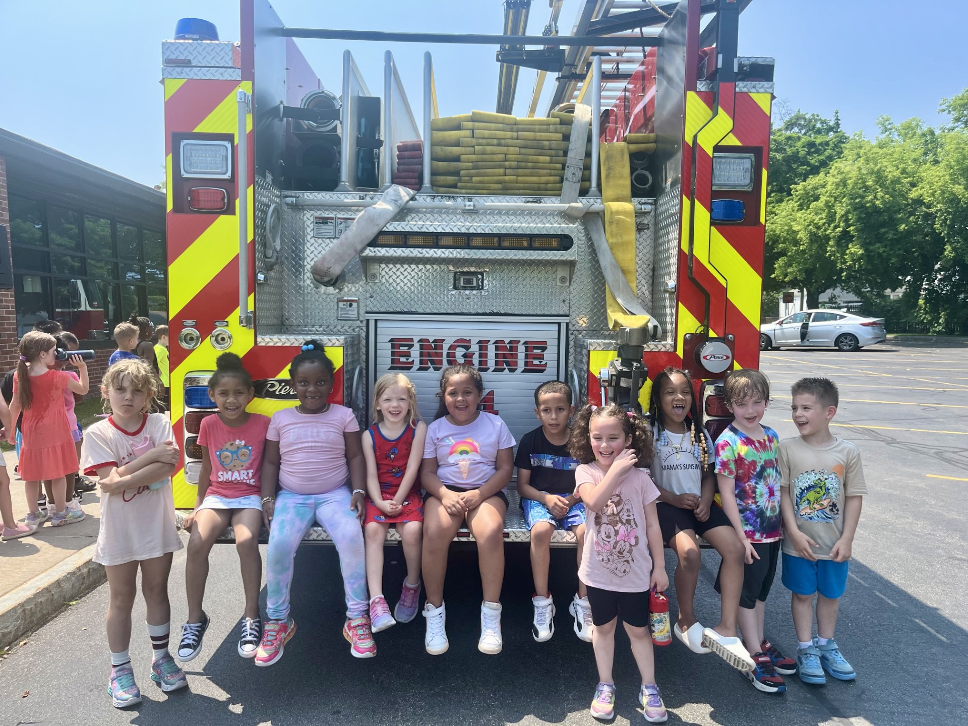 Kids in front firetruck