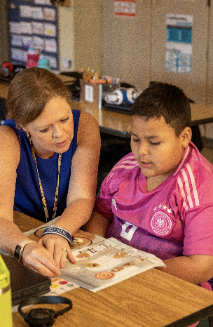 Principal Leslie Springston works with a student during WIN time (What I Need) at Simpsonville Elementary.