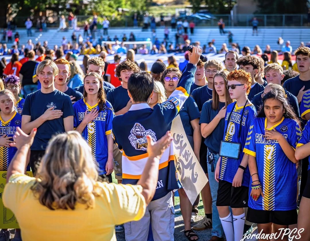 Athletes and Choir singing the national anthem