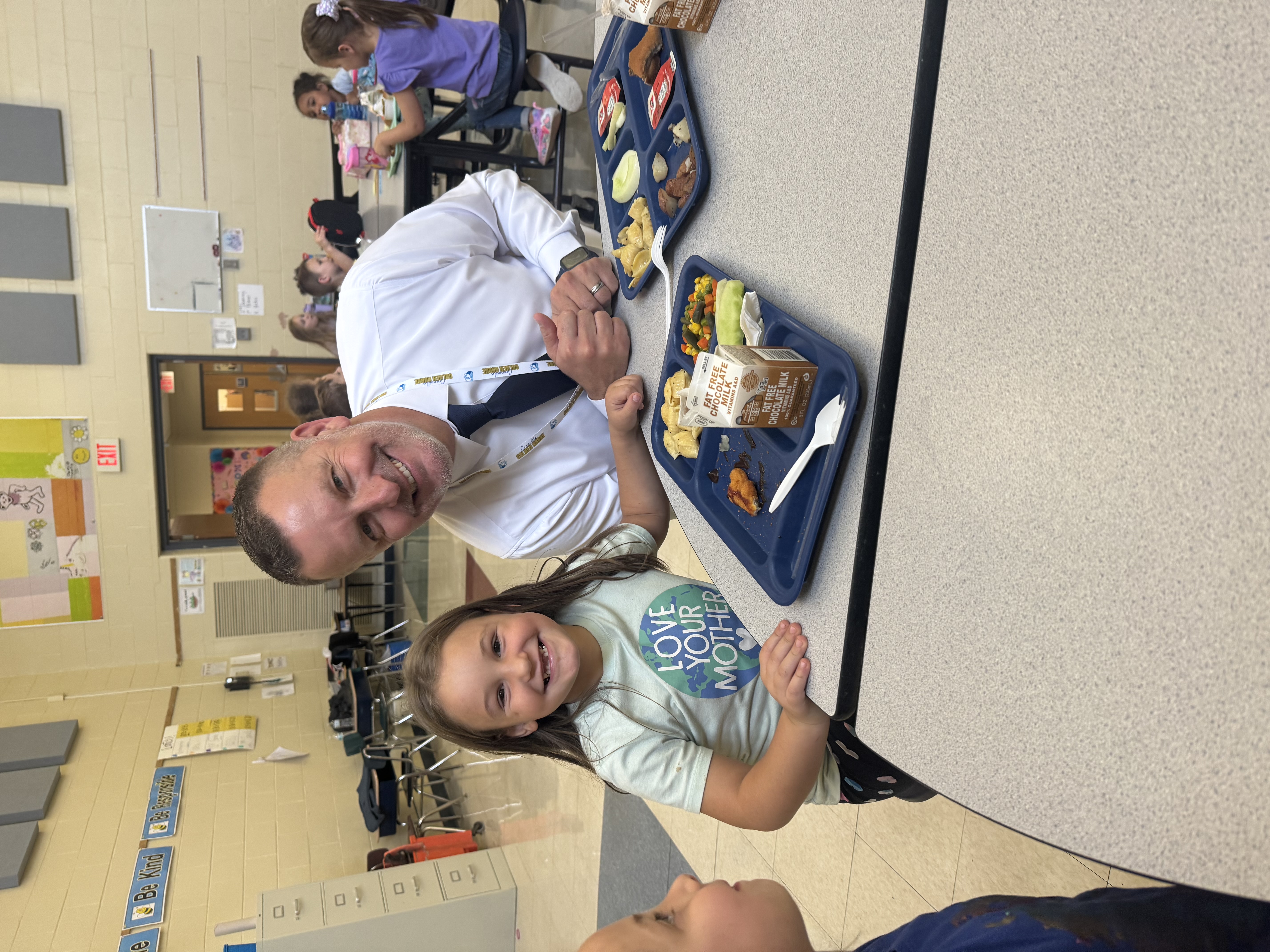 a picture of mr. hall with a student at lunch