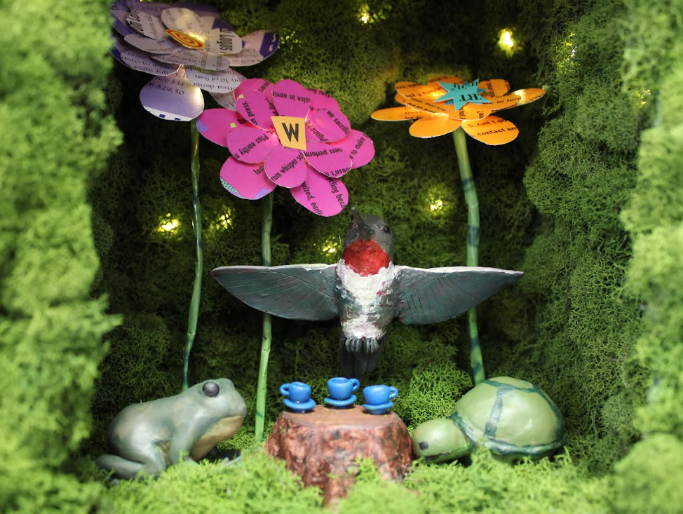 Diorama with a bird, frog, and flowers