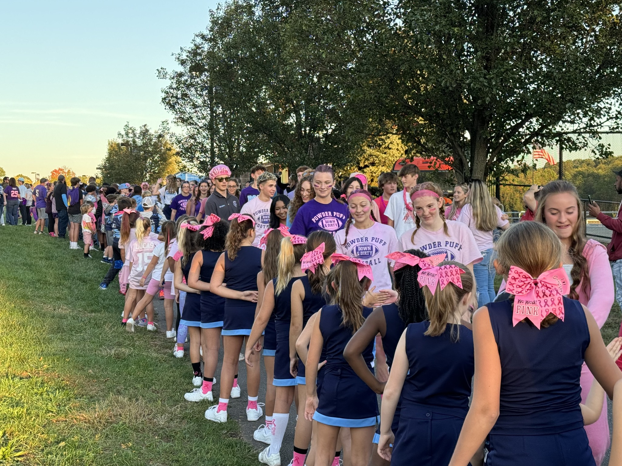 Powder Puff team members get high fives from our midget cheerleaders