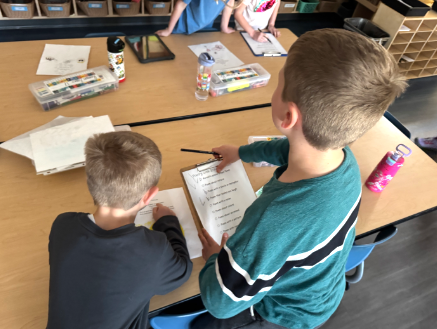 Two young boys with poetry sheets