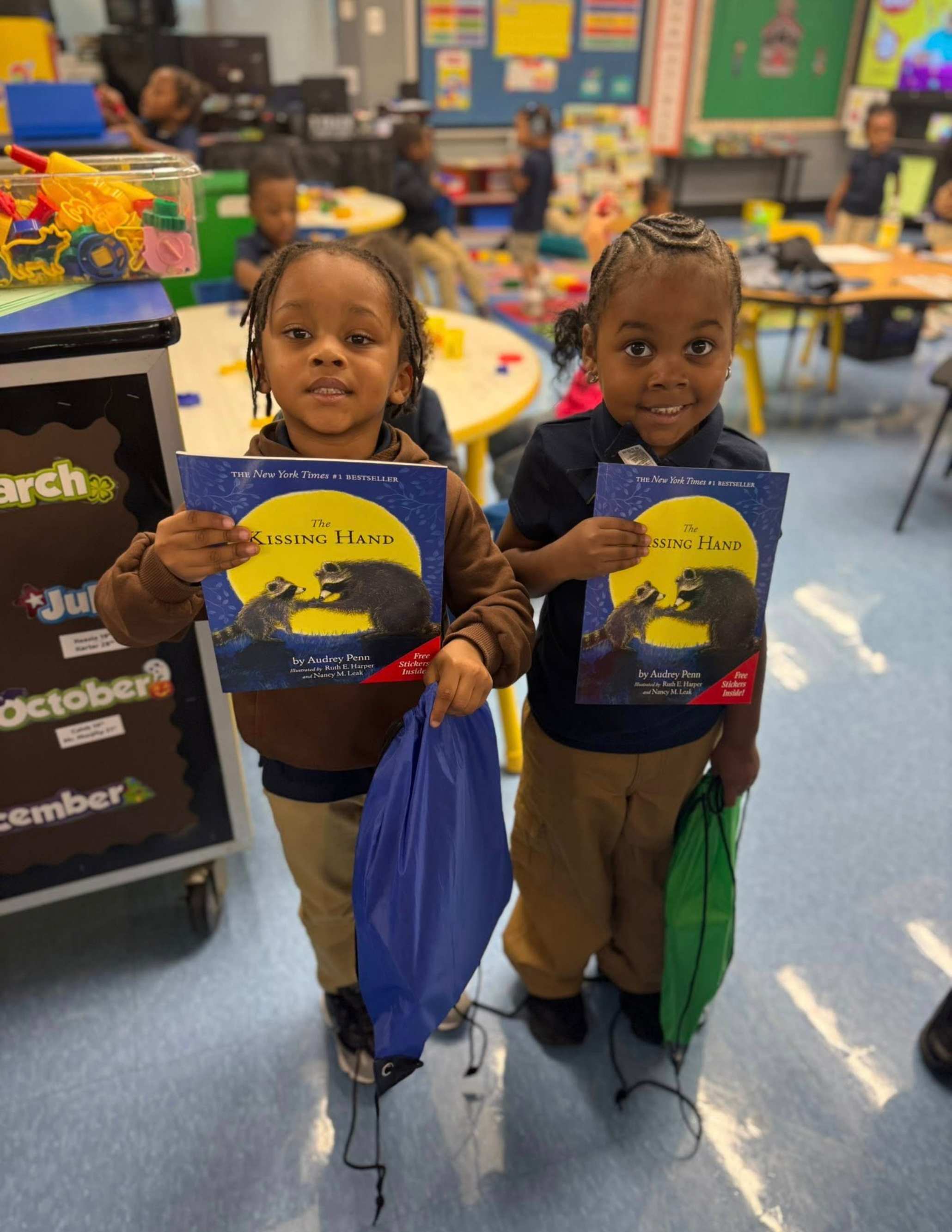 2 students holding books at Moravia Judy Center