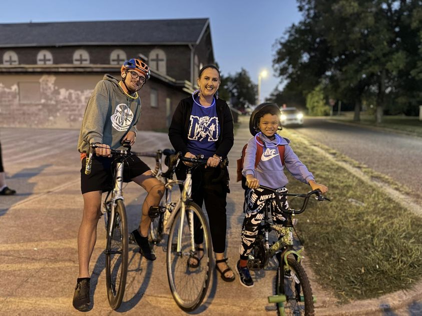 Adult man and woman and child on bikes