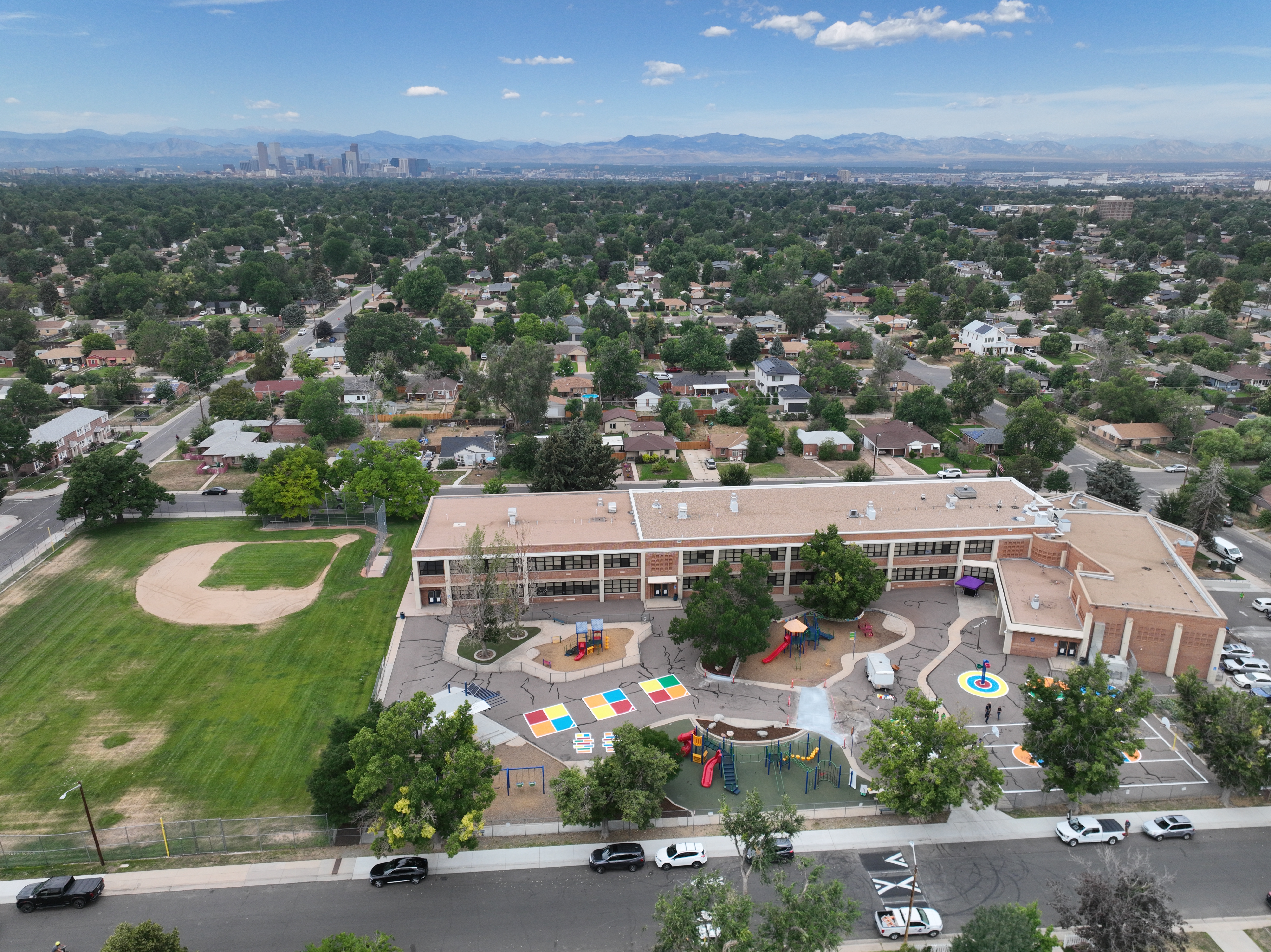 Aerial image of Hallett Academy with Denver and the mountains in the background