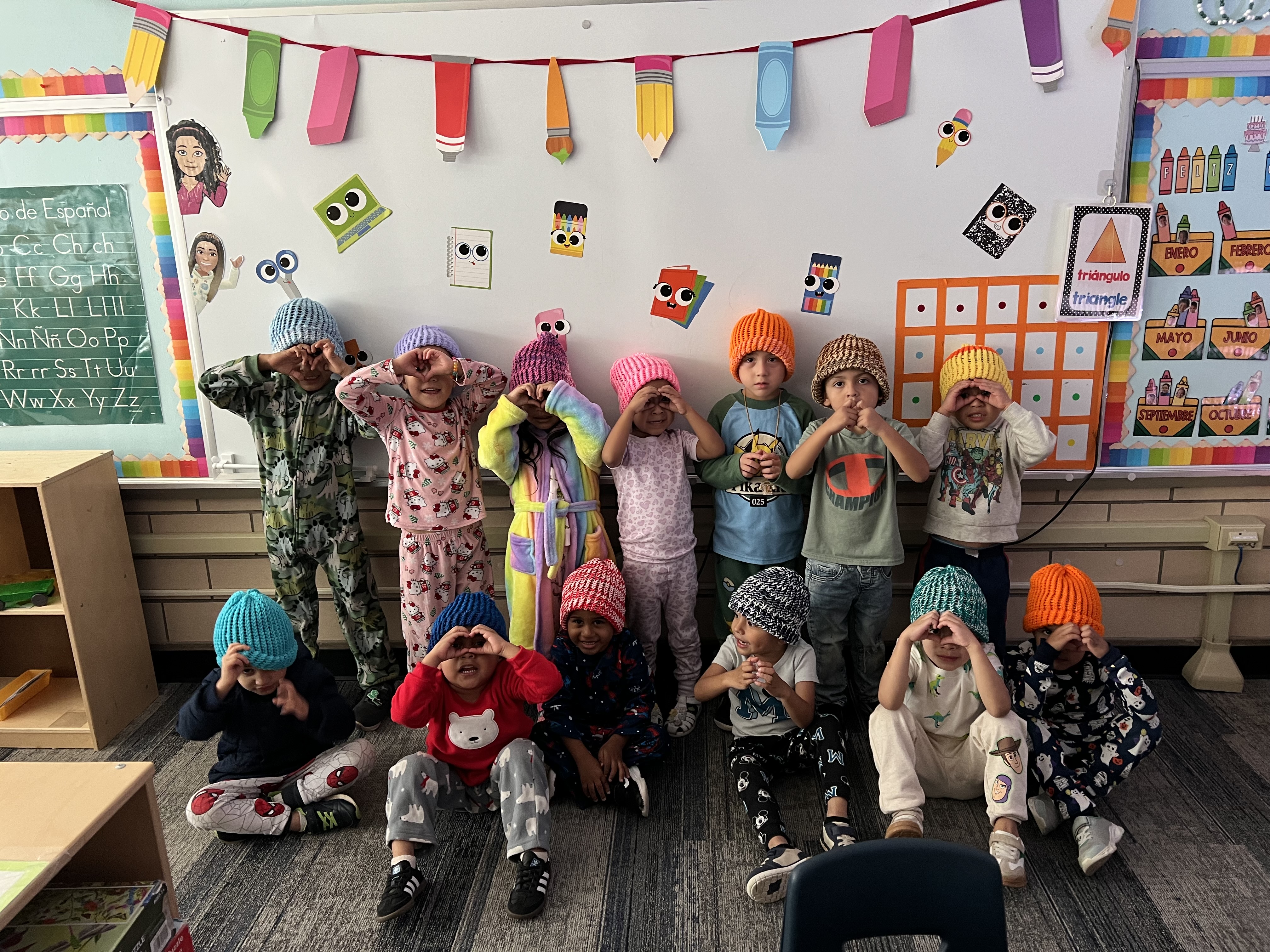 ECE smiles with their beanies made for them by a local member of the community.