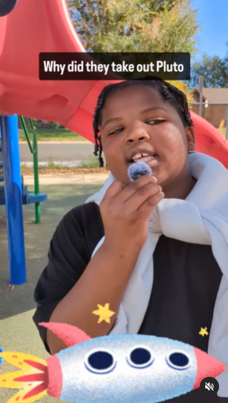 Hallett student on the playground talking into a mini mic