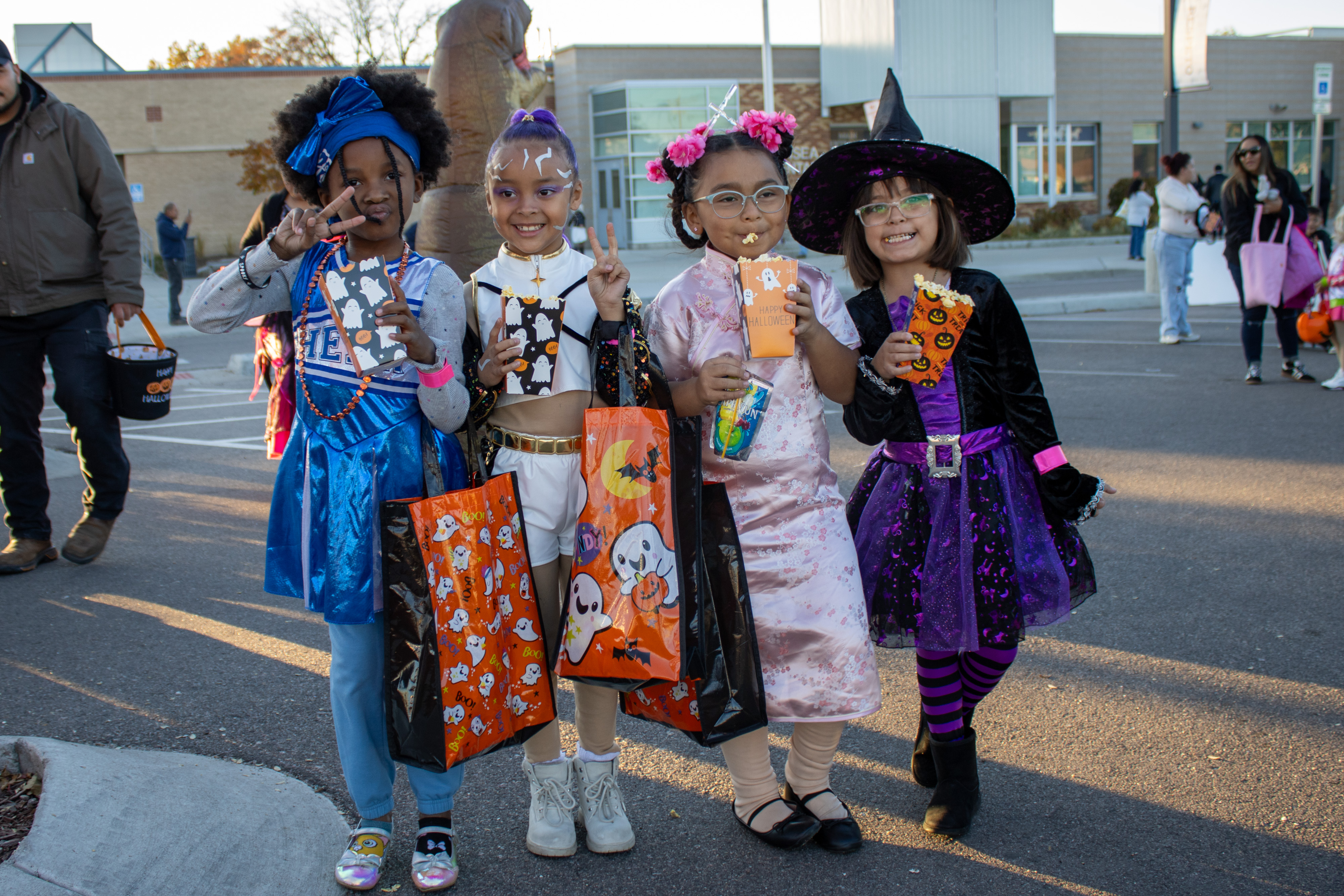 A group of students pose for a photo at Trunk or Treat.