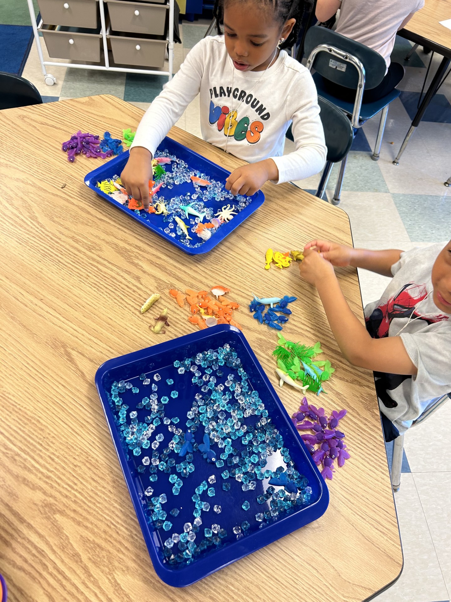 Students playing with ocean toys