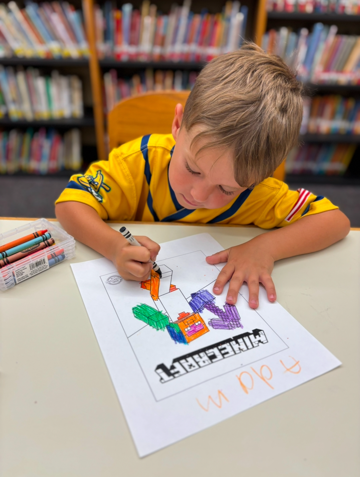 a picture of a boy coloring