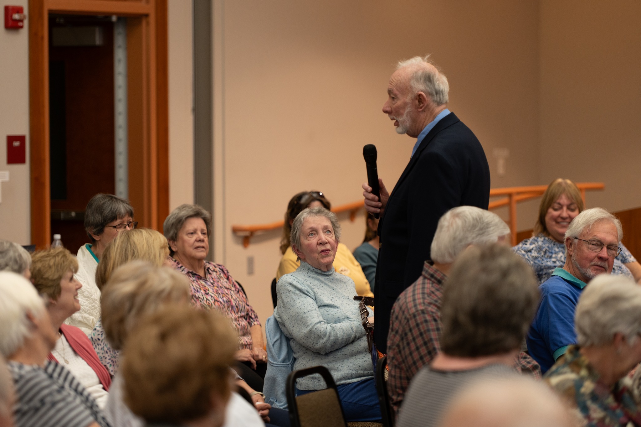 Gentleman speaking in front of a crowd of seated guests