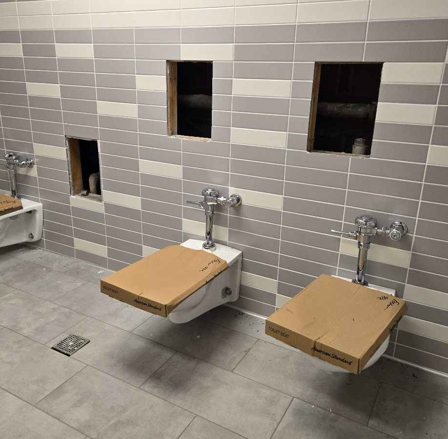 bathroom with fresh tiles, flooring and toilets