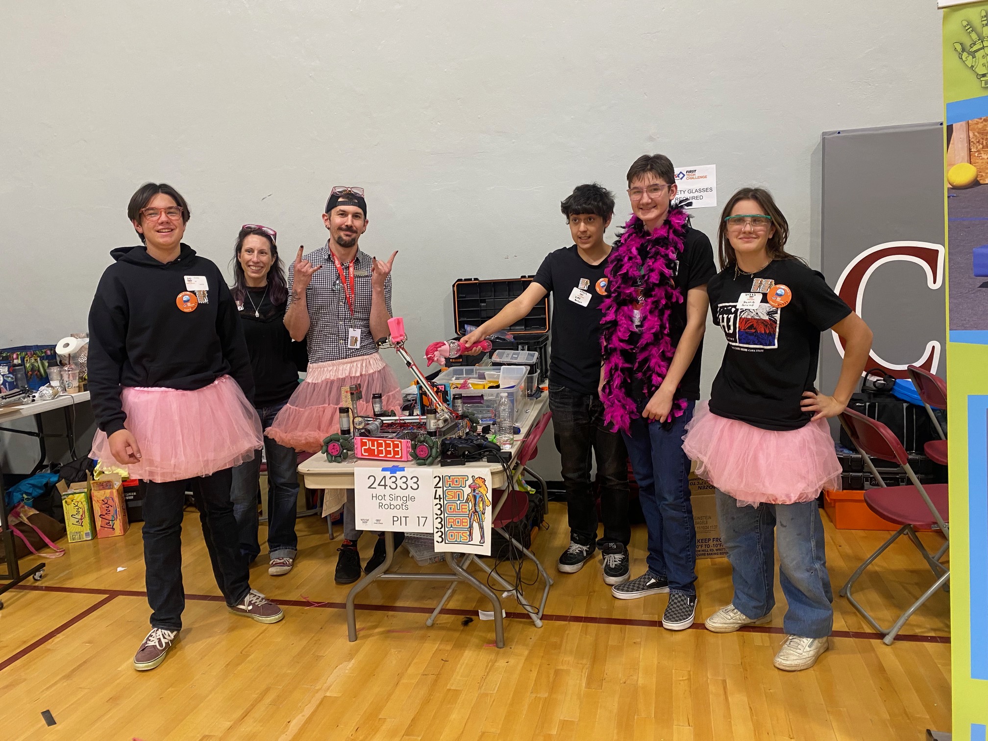 Tech Challenge Competition team smiles in pink tutus for the camera