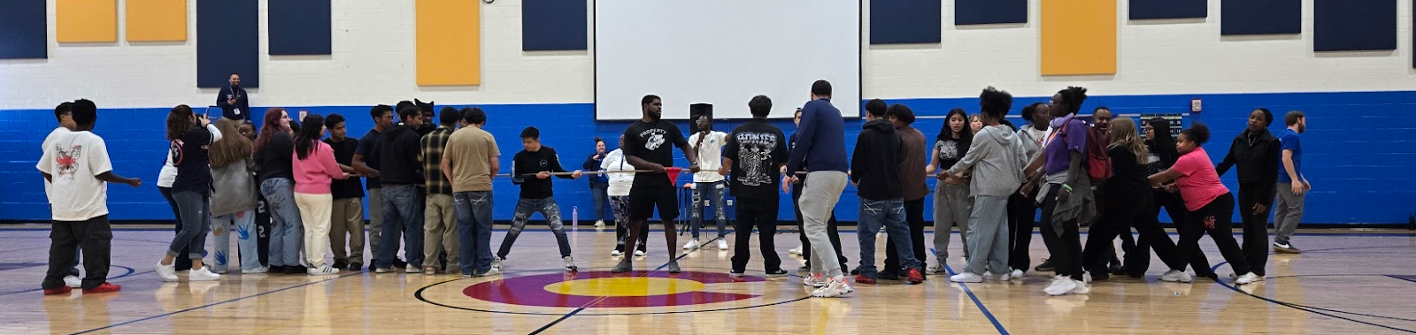Students playing tug of war in the gym
