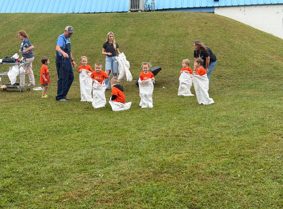 Students participate in a sack race