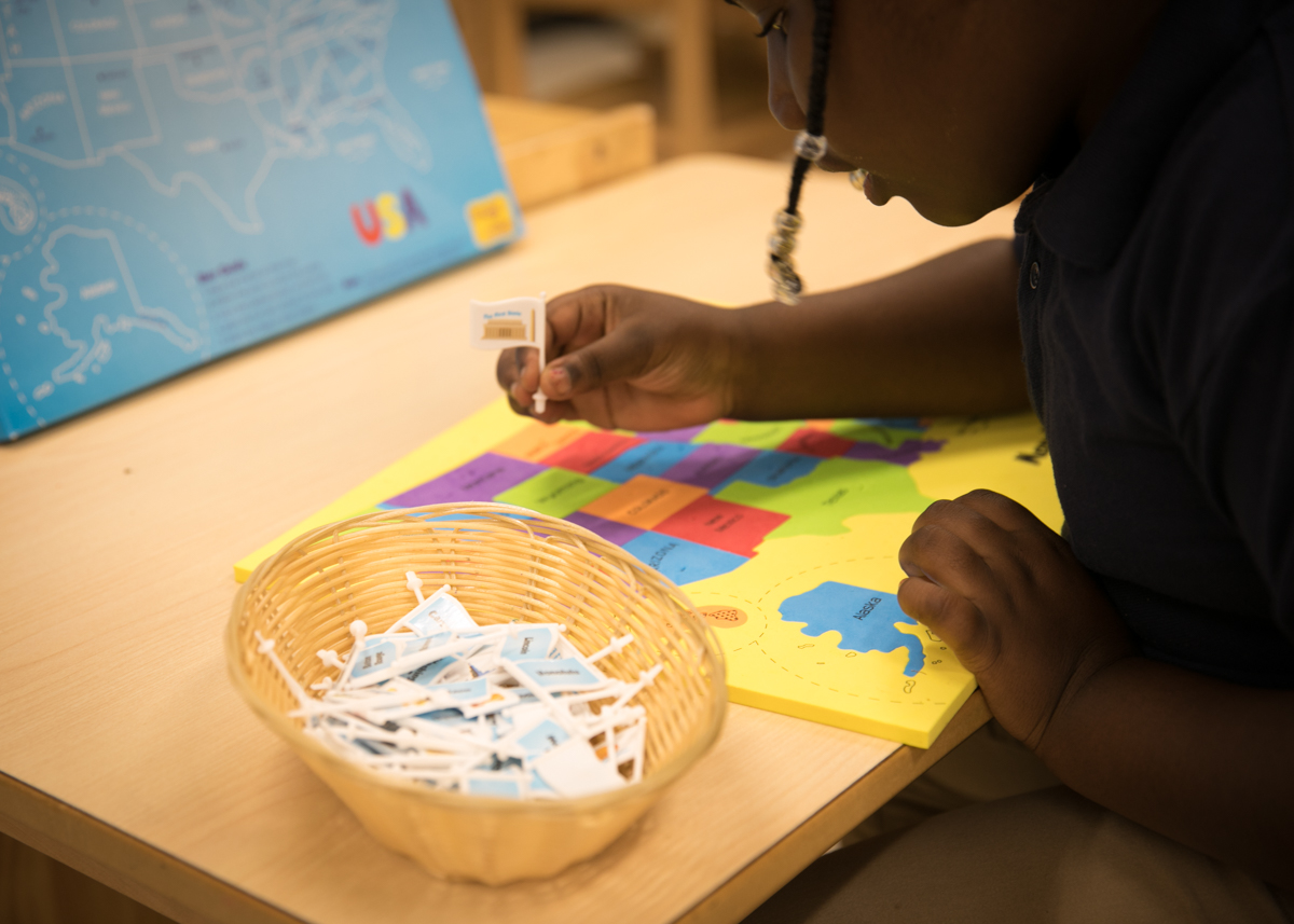 Student working with Montessori materials