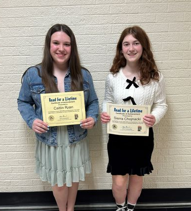 image of two school aged girls holding awards and posing for a photo