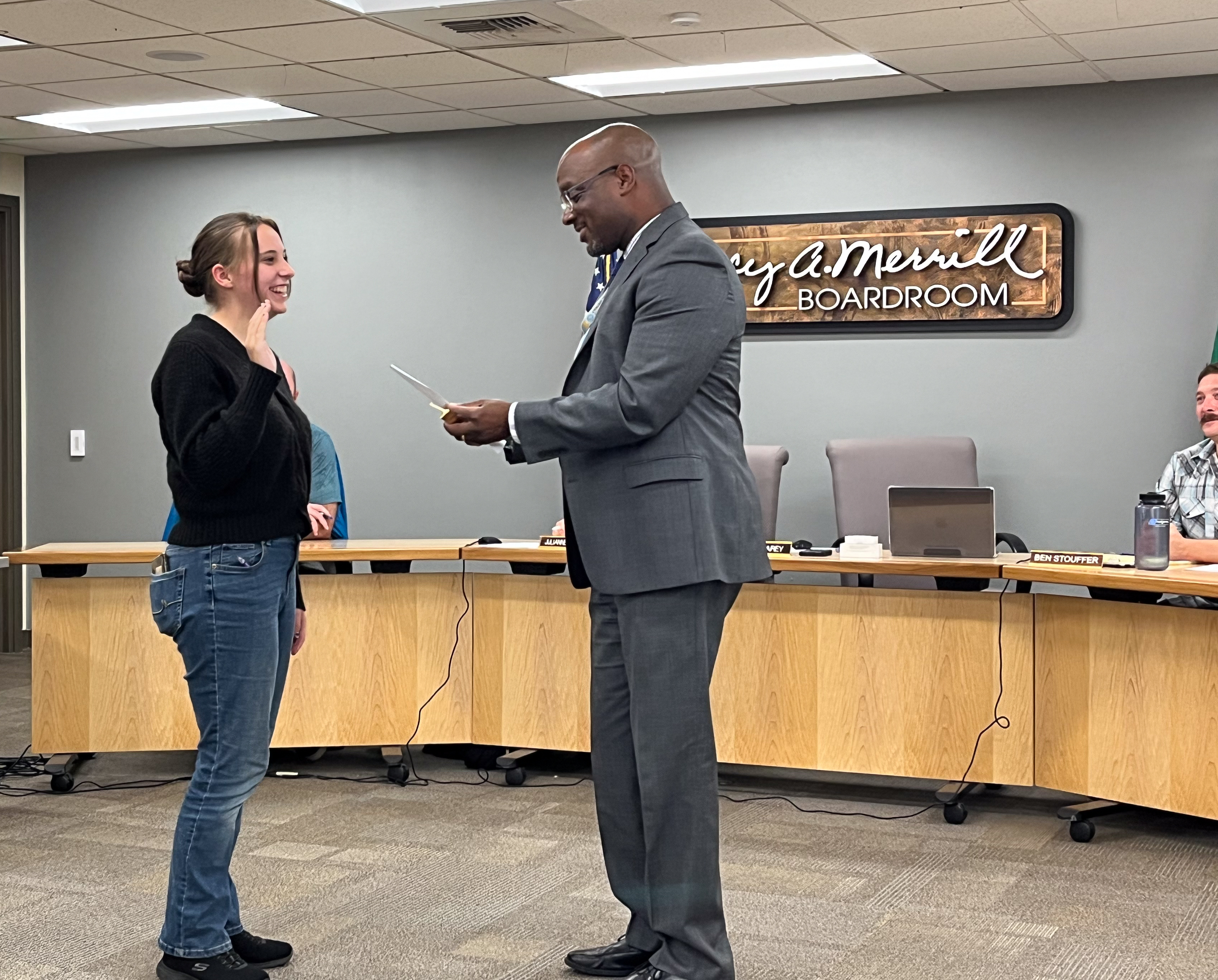 Junior Board Rep Makhya Walls repeating her oath of office to Dr. Carey