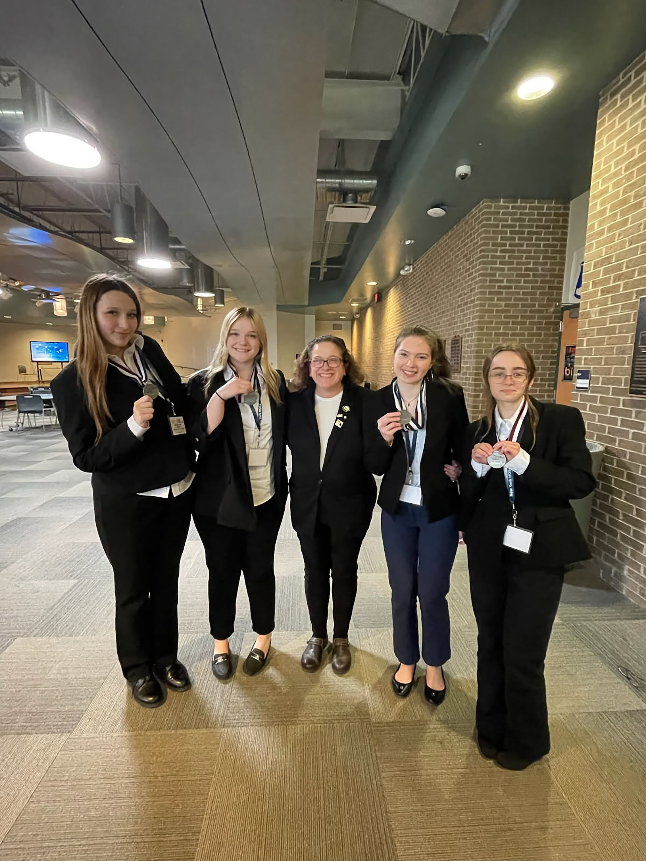 Four Health Science Careers students witih teacher and awards