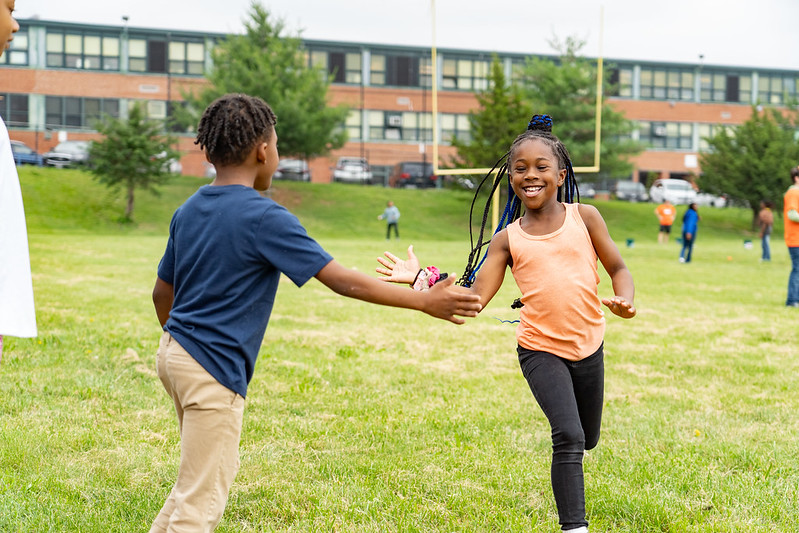 Students giving high five in school yard