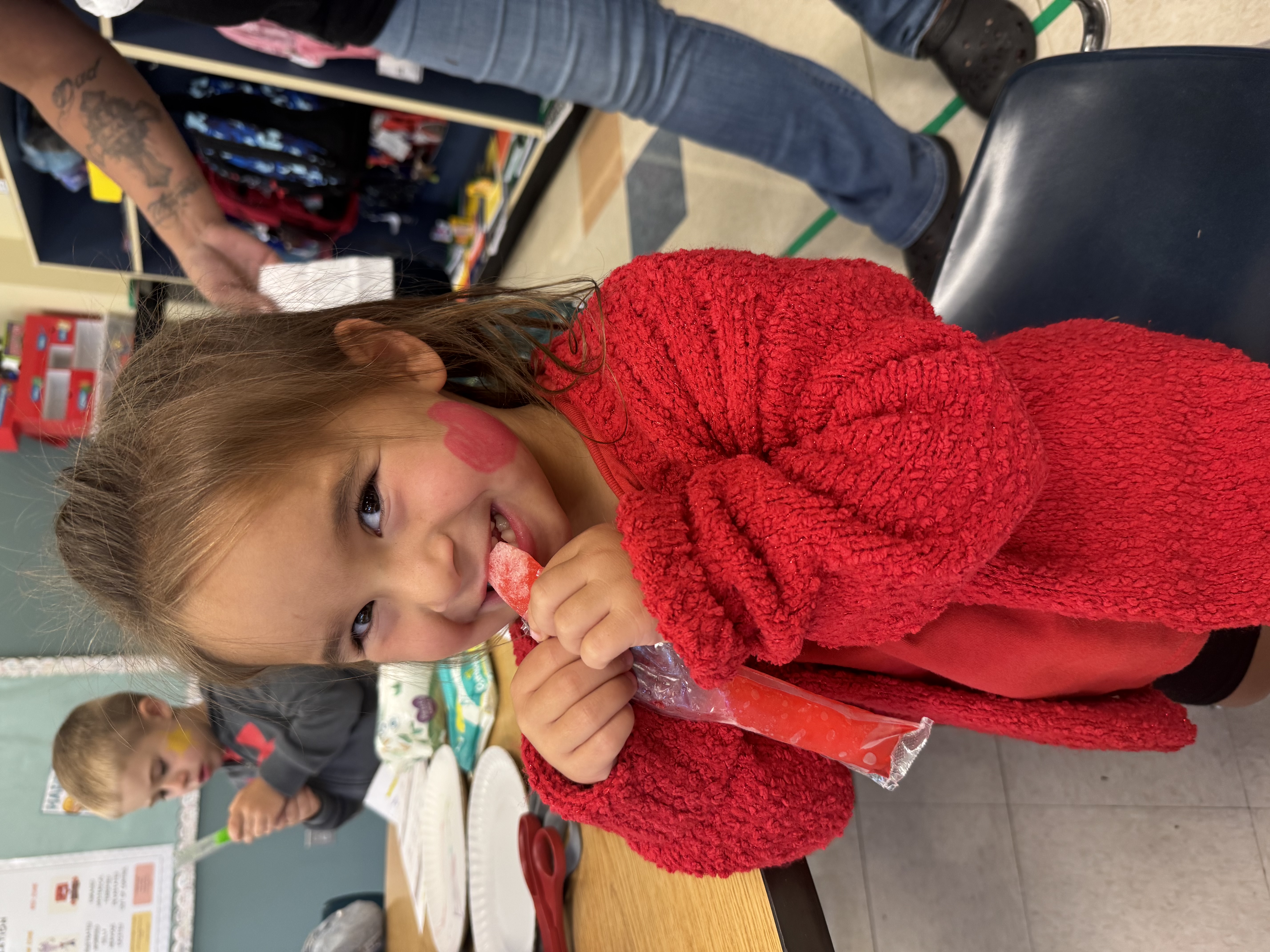 a picture of a little girl enjoying an ice pop