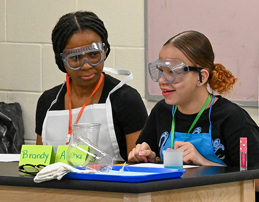 Two students wearing googles in science lab at Sullivan School