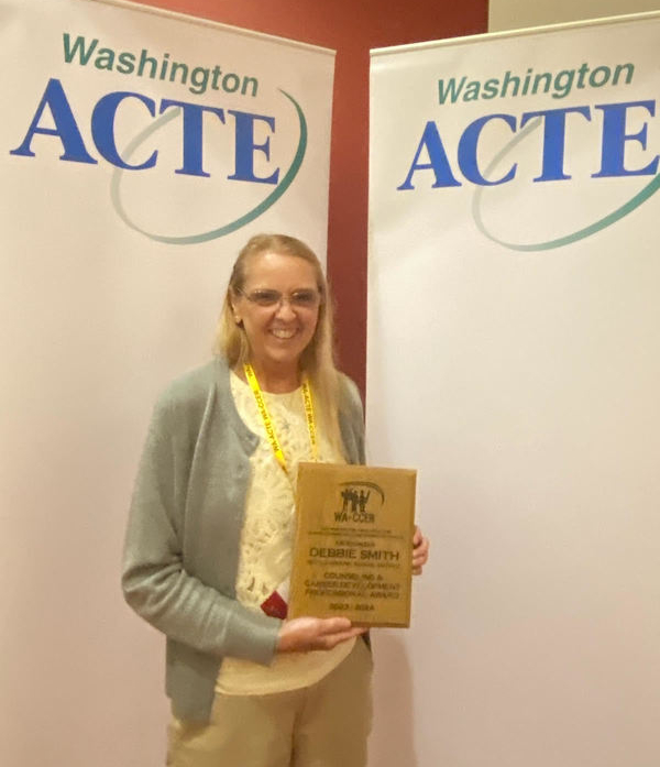 Debbie Smith holds her award from ACTE