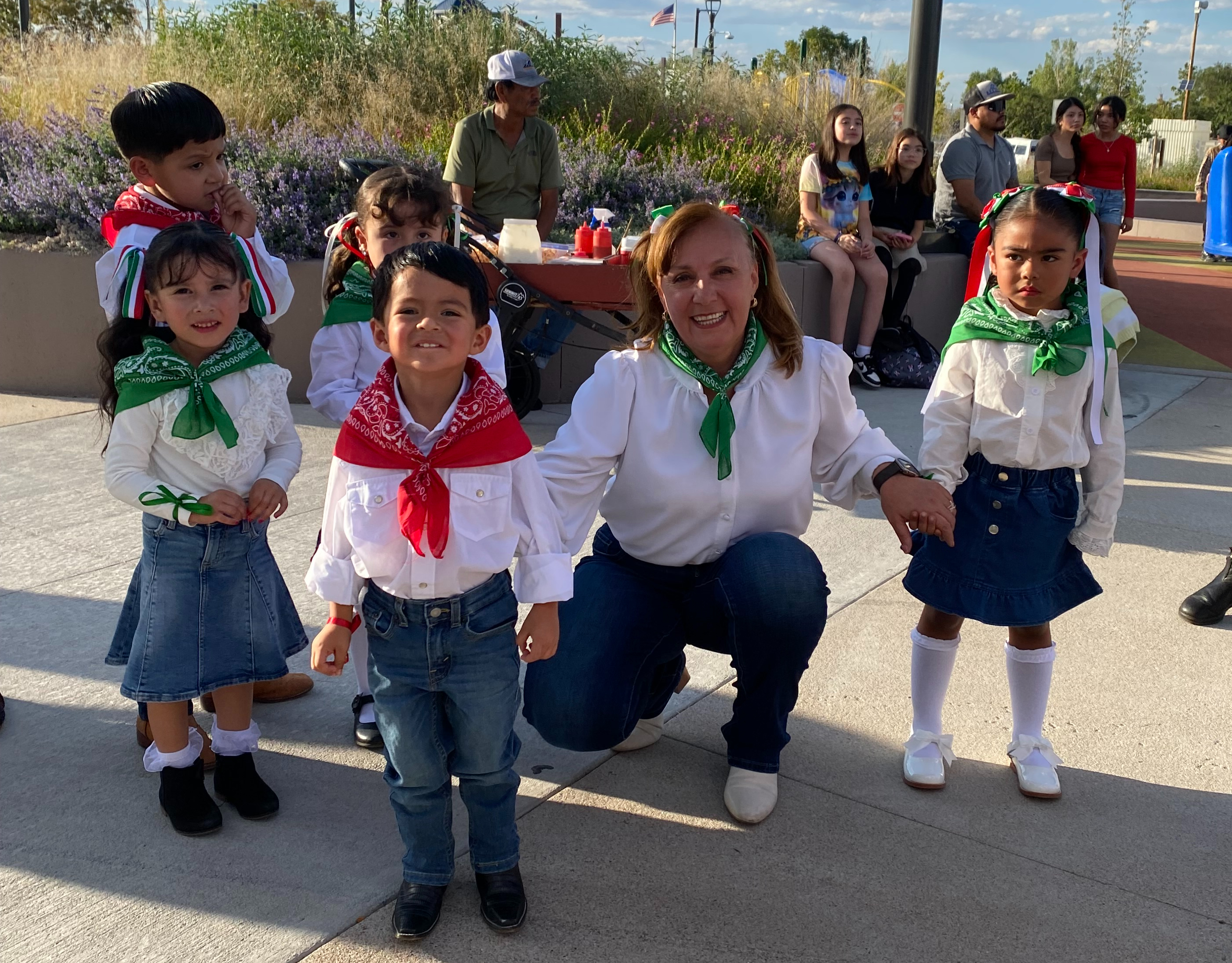 Students smile with their teacher at Fiesta Hispana