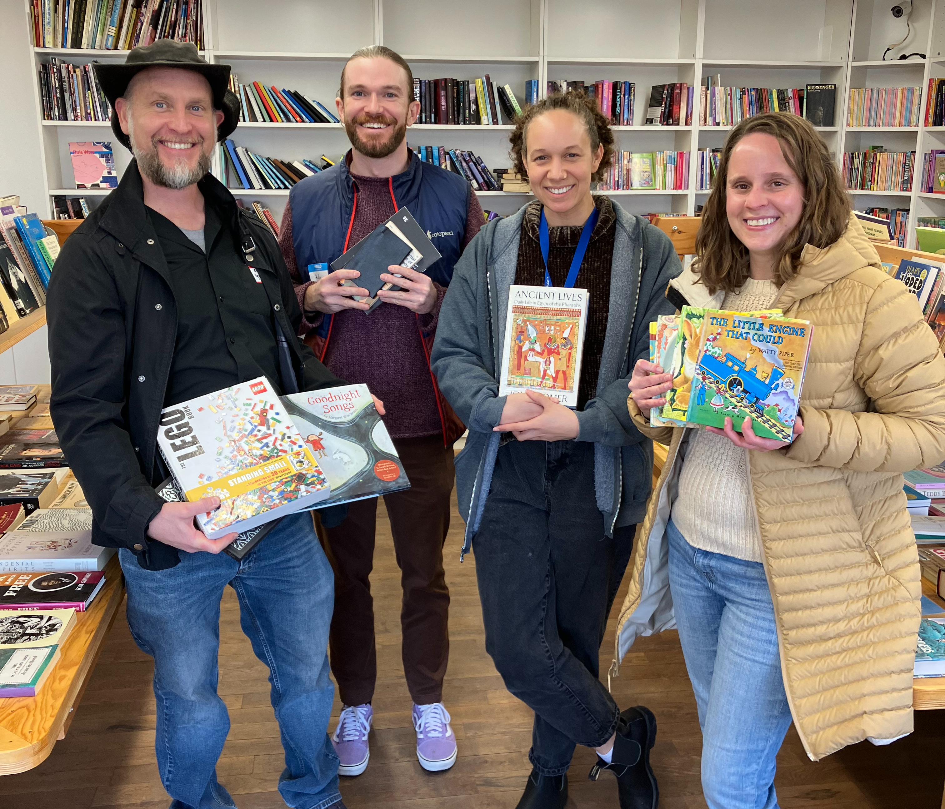 staff pose with books in the bookstore