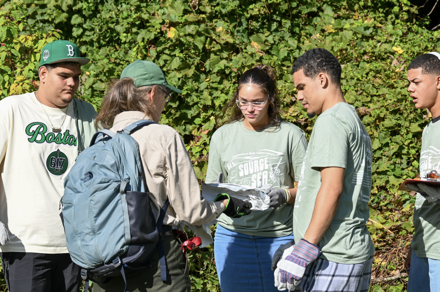 Volunteer teaches students how trash tallies work