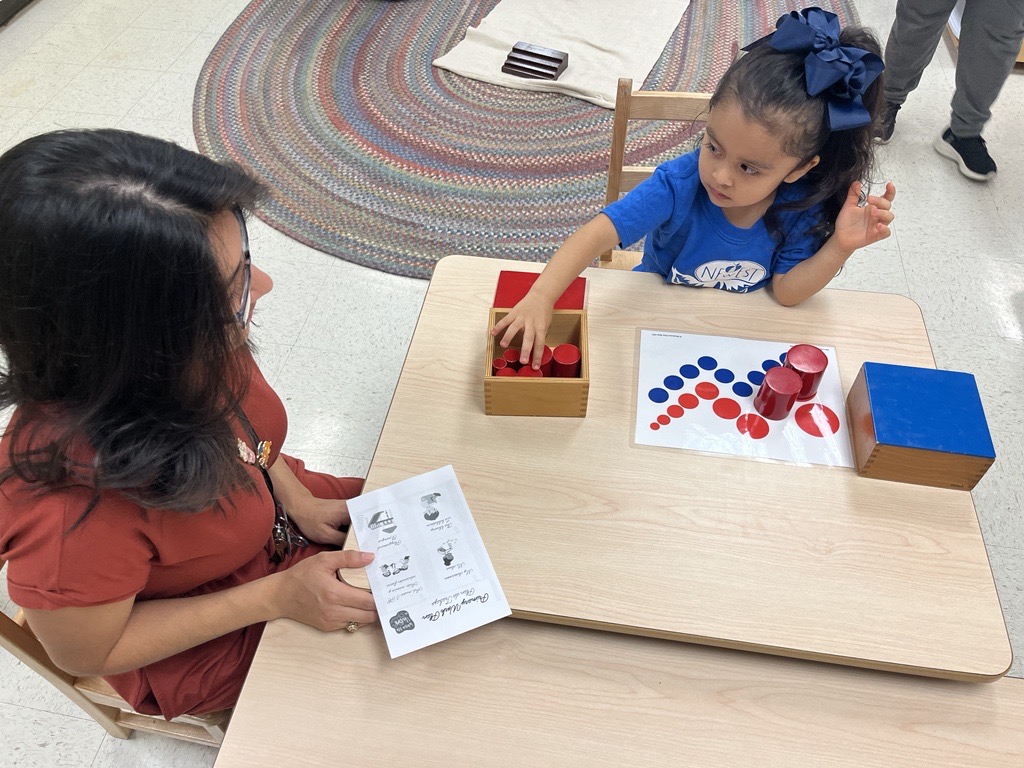 Child shows parent Montessori materials