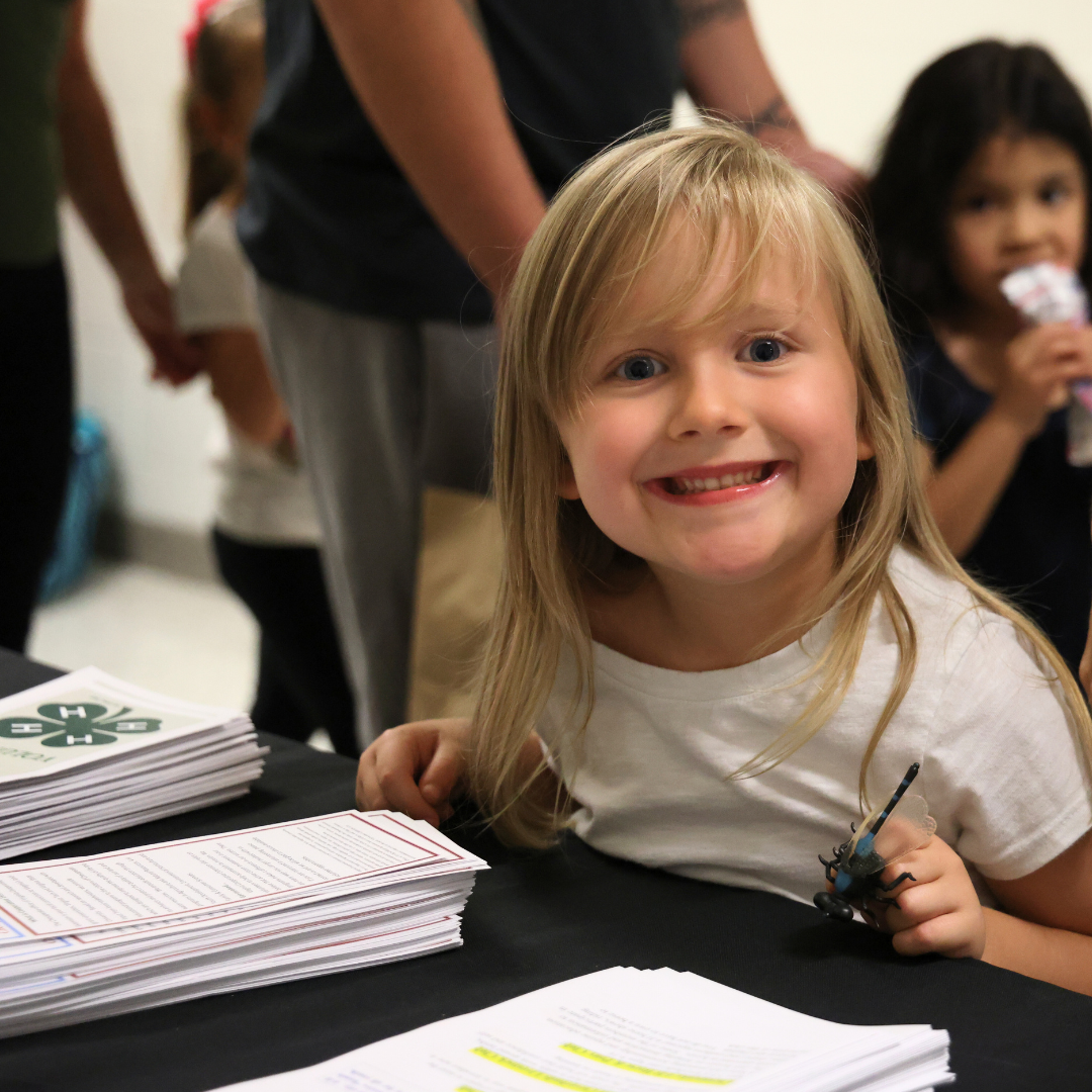 Picture of a smiling child at a community resource fair.