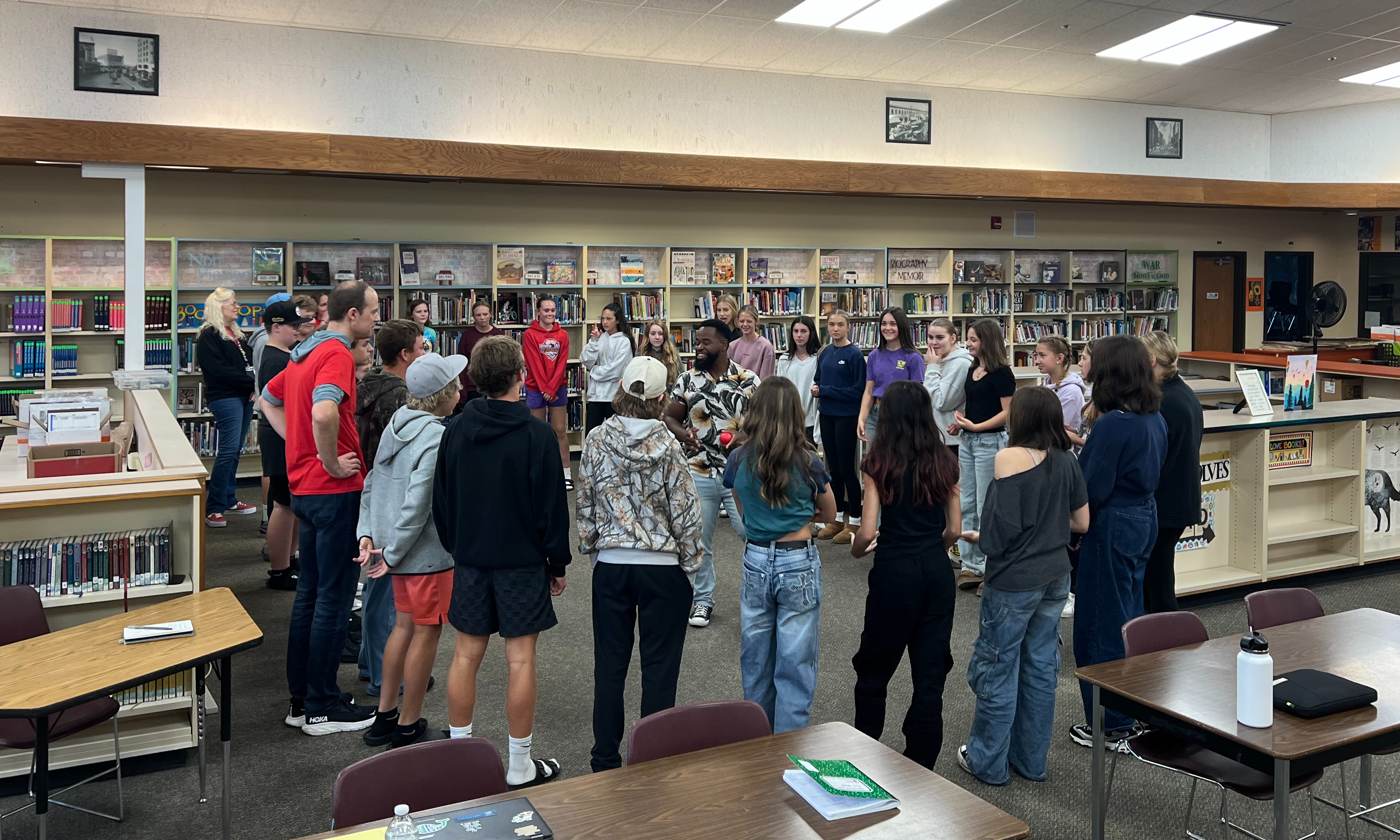 EMS Leadership students in a circle listening to keynote speaker 