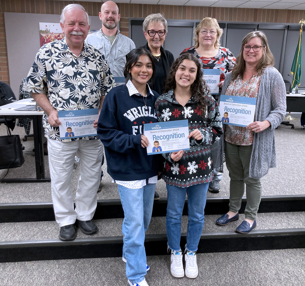 Members of the Battle Ground school board pose with certificates of recognition from the state