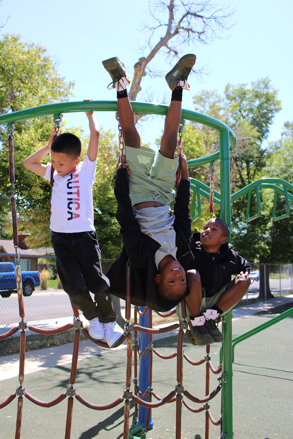 3 kids playing on the playground