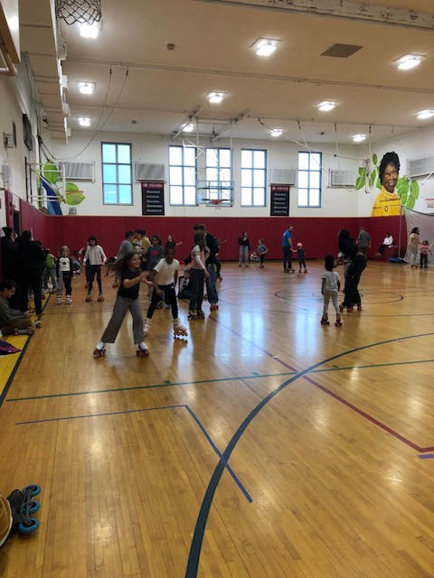 Students rollerblade around BJM gym. 