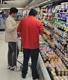 Aref chooses cheese with the help of the customer service rep