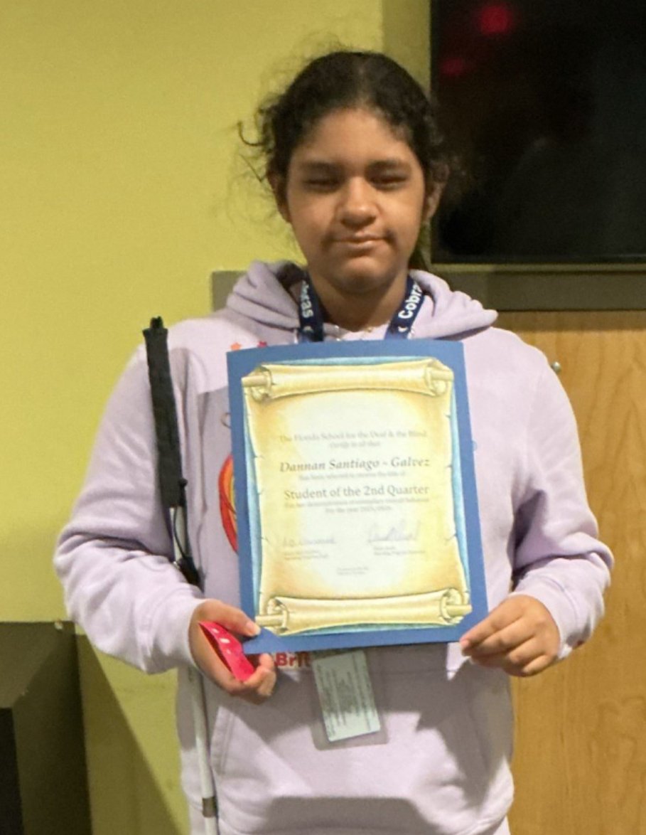 Danna holding her Student of the Month Certificate