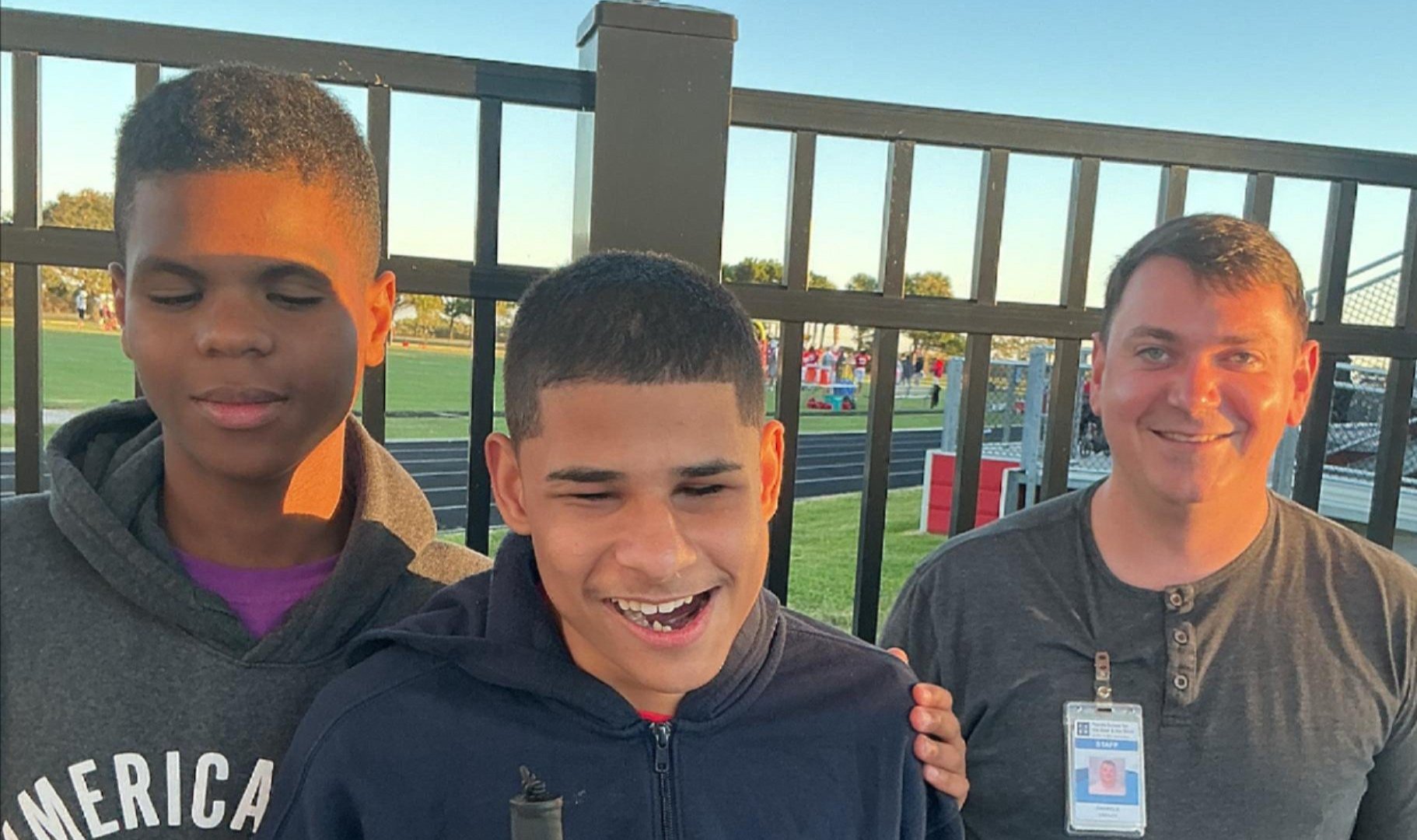Juniell, Carlos, Mr. Gabriel standing by the football field on a bright sunny evening