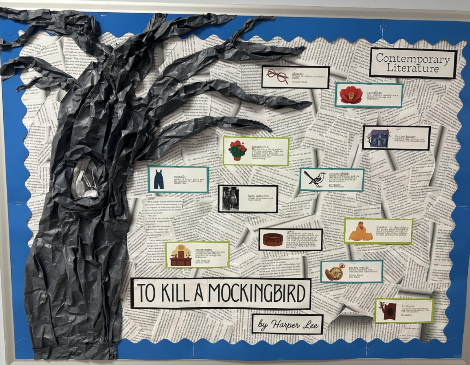 To Kill a Mockingbird bulletin board with a 3D tree, book pages as the background, and parts of the book
